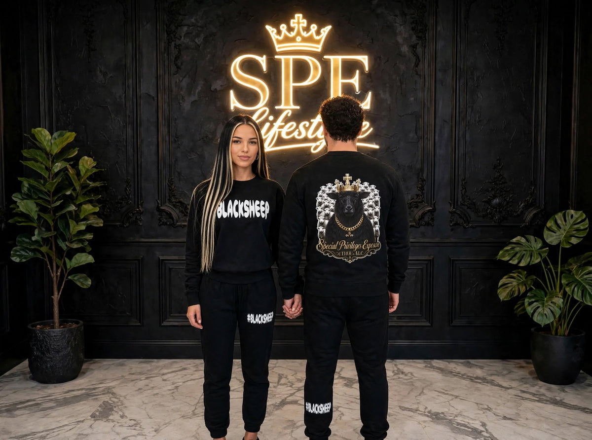 Man and woman wearing black #BLACKSHEEP sweatshirts and joggers on a city street